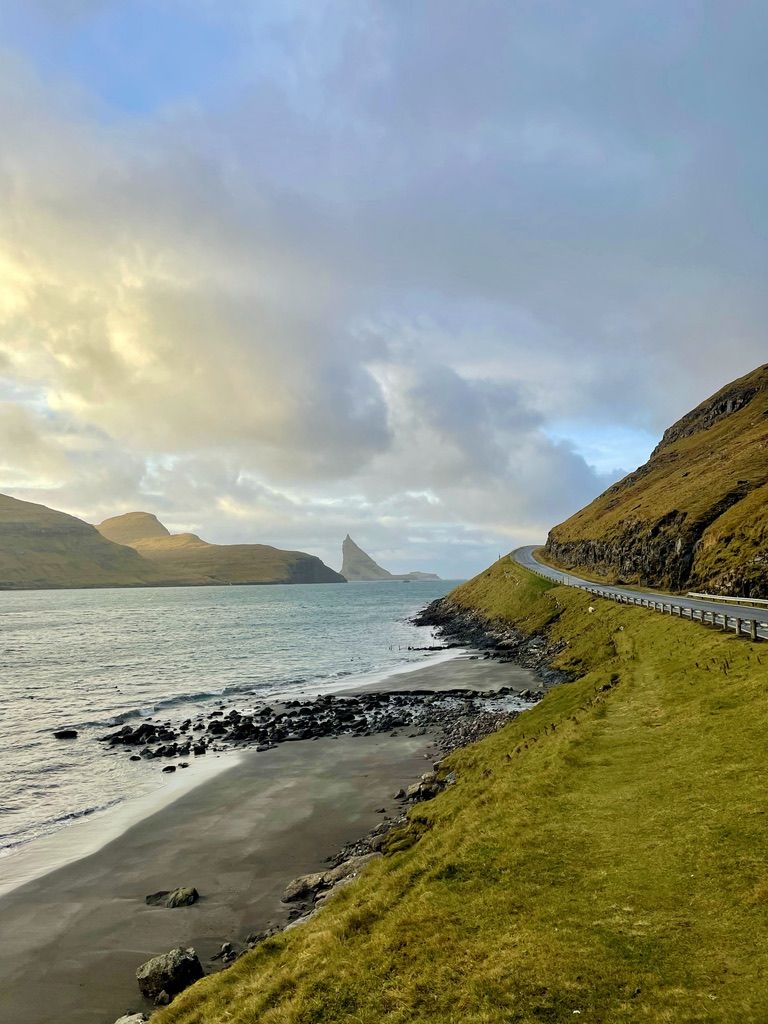 Coastal road overlooking a sea stack, Faroe Islands